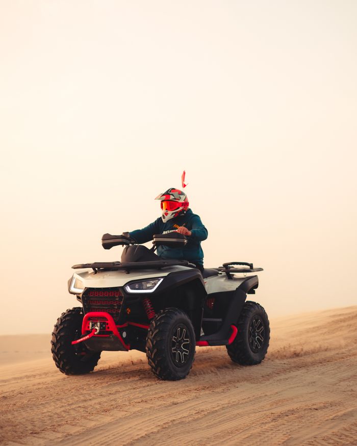 Experience the adrenaline of quad biking across the stunning sand dunes of Doha, Qatar.